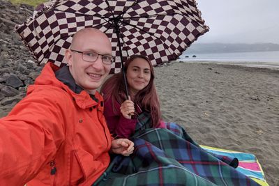 Joel and Rachel eating a takeaway on An Corran Beach